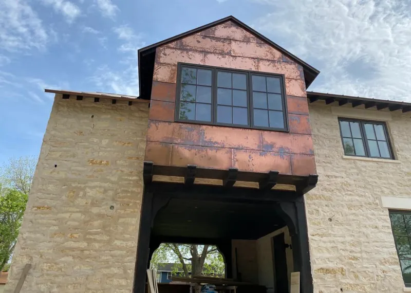 Copper metal panel facade on a stone building for Metal Roof Coating in Vermillion