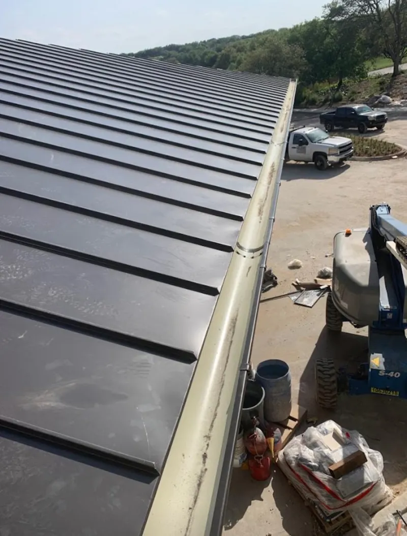 Standing seam panel and gutter detail on a metal roofing jobsite in Vermillion